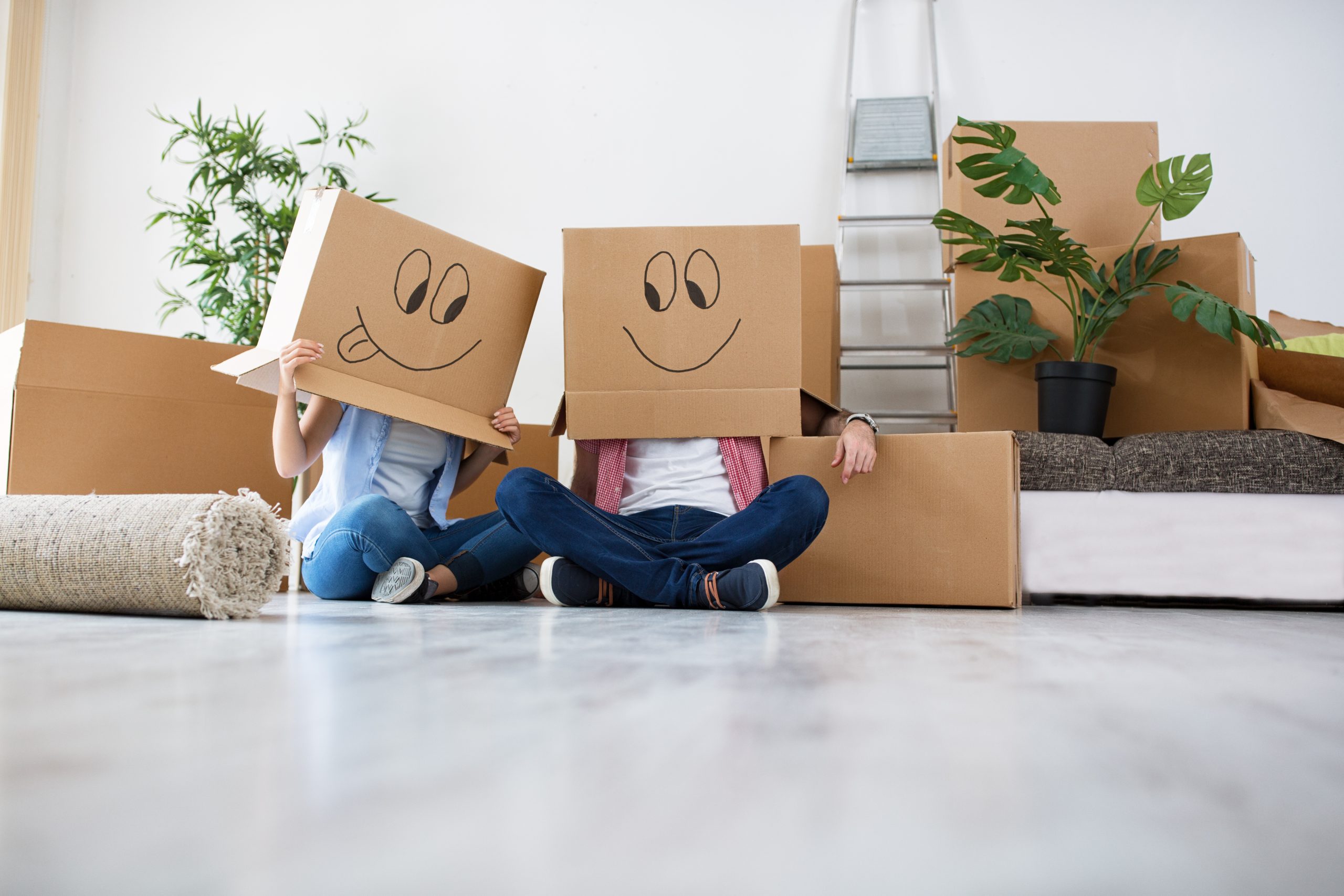 Funny young couple enjoy and celebrating moving to new home, moving concept
